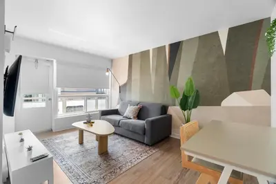 a living room with a couch and a table at Hotel Laurence in Montréal