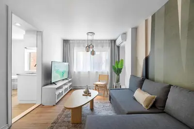 a living room with a couch and a tv at Hotel Laurence in Montréal
