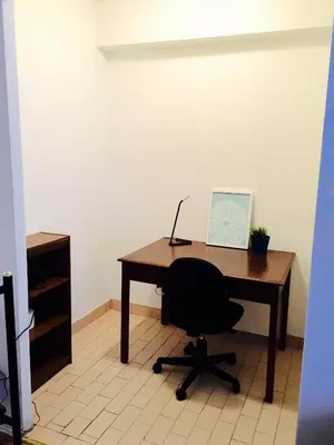 an office with a desk with a chair and a laptop at Stylish Montreal Apartment: Comfortable Stay in the Golden Square Mile in Montréal