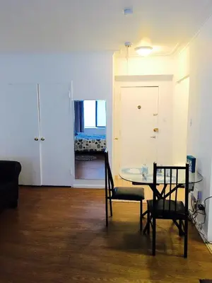 a room with a table and two chairs and a bedroom at Stylish Montreal Apartment: Comfortable Stay in the Golden Square Mile in Montréal