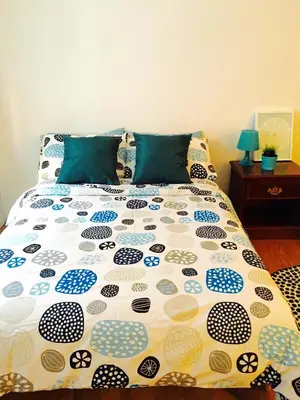 a bed with a comforter on it in a bedroom at Stylish Montreal Apartment: Comfortable Stay in the Golden Square Mile in Montréal