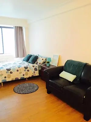 a living room with a couch and a bed at Stylish Montreal Apartment: Comfortable Stay in the Golden Square Mile in Montréal