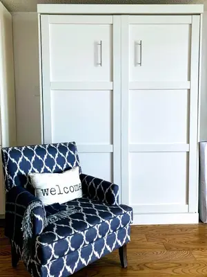 a blue couch in a living room with two doors at OMagogcondo com A in Magog-Orford