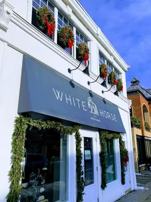 a white bird house sign on the side of a building at OMagogcondo com B in Magog-Orford