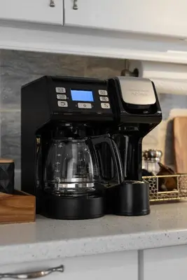 a black coffee maker sitting on a kitchen counter at Cozy Family Home Near Montreal in Brossard
