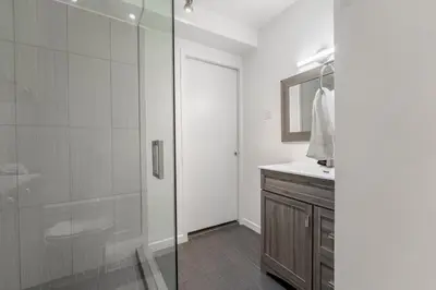 a bathroom with a shower and a toilet and a sink at Cozy Family Home Near Montreal in Brossard