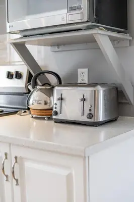 a toaster sitting on top of a kitchen counter at Cozy Family Home Near Montreal in Brossard