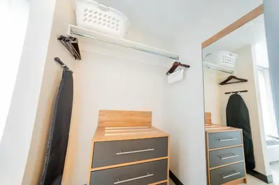 a closet with a dresser and a mirror at Candlewood Suites Trois-Rivières Ouest by IHG in Trois-Rivières
