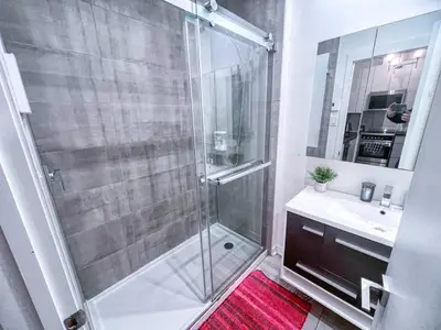 a bathroom with a shower and a sink at The Downtown Zando in Montréal