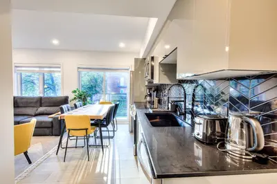 a kitchen and living room with a table and chairs at Le Montreal Adventure! Restful Nights Full Kitchen & Fast Wifi in Montréal