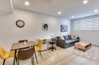 a living room with a couch and a table at Le Montreal Adventure! Restful Nights Full Kitchen & Fast Wifi in Montréal
