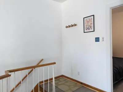 a staircase in a house with white walls at 2 Bedrooms, 1 Sofa bed and 1,5 Bathrooms, Renovated Apartment in the Heart of Plateau Mont-Royal in Montréal