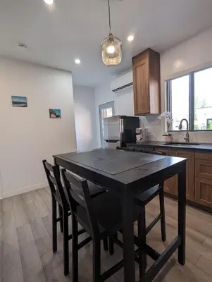 a kitchen with a black table and some chairs at 2 Bedrooms, 1 Sofa bed and 1,5 Bathrooms, Renovated Apartment in the Heart of Plateau Mont-Royal in Montréal