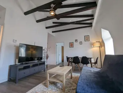 a living room with a couch and a tv and a table at 2 Bedrooms, 1 Sofa bed and 1,5 Bathrooms, Renovated Apartment in the Heart of Plateau Mont-Royal in Montréal