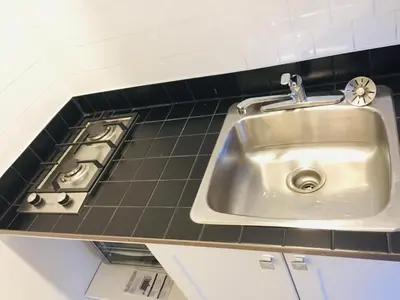 a sink in a kitchen next to a stove at Stylish Montreal Apartment in Montréal