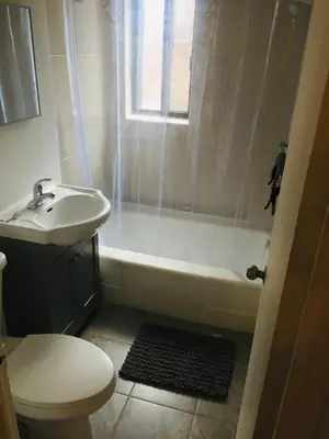 a bathroom with a sink and a tub and a toilet at Stylish Montreal Apartment in Montréal