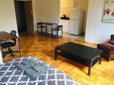 a living room with a coffee table and a kitchen at Stylish Montreal Apartment in Montréal