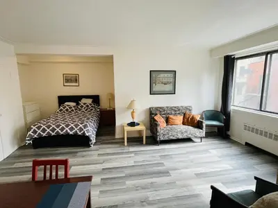 a bedroom with a bed and a couch at Stylish Montreal Apartment in Montréal