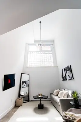 a living room with a couch and a table at Le Mile End by M11 - Modern Luxe 1BDR with Sofa Bed in Montréal