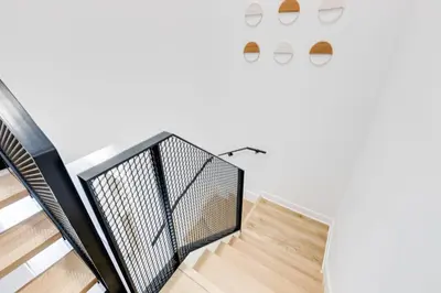 a staircase in a house with a white wall at Le Mile End by M11 - Modern Luxe 1BDR with Sofa Bed in Montréal