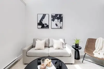 a living room with a couch and a table at Le Mile End by M11 - Modern Luxe 1BDR with Sofa Bed in Montréal