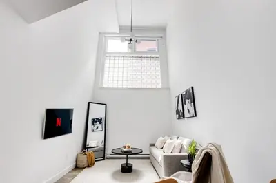 a living room with a couch and a window at Le Mile End by M11 - Modern Luxe 1BDR with Sofa Bed in Montréal