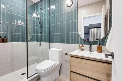 a bathroom with a toilet and a shower and a sink at Le Mile End by M11 - Modern Luxe 1BDR with Sofa Bed in Montréal