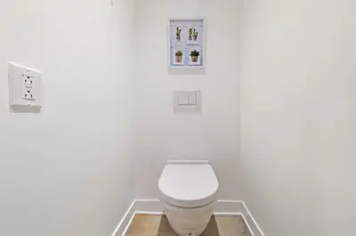 a bathroom with a white toilet in a room at Old Montreal's Luxe Charm in Montréal