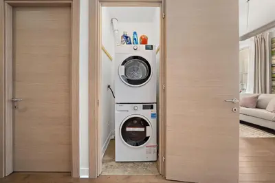 a washer and dryer in a room next to a door at Old Montreal's Luxe Charm in Montréal
