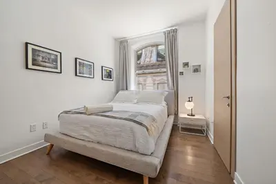 a bedroom with a bed and a window at Old Montreal's Luxe Charm in Montréal
