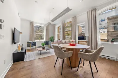 a living room with a table and chairs at Old Montreal's Luxe Charm in Montréal