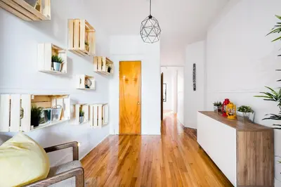 a living room with white walls and a wooden door at Frontenac residences in Montréal