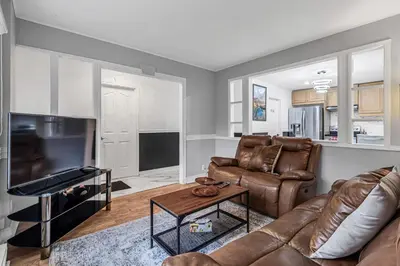 a living room with a couch and a table at 2 BDR -10 min de la Ronde et Parc Jean Drapeau South Shore Montreal in Longueuil