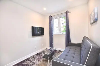 a living room with a couch and a window at Beautiful 2BDR in Heart of Plateau Mont-Royal A in Montréal