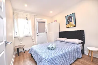 a small bedroom with a bed with a blue blanket at Beautiful 2BDR in Heart of Plateau Mont-Royal A in Montréal