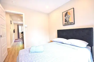 a bedroom with a bed and a picture on the wall at Beautiful 2BDR in Heart of Plateau Mont-Royal A in Montréal