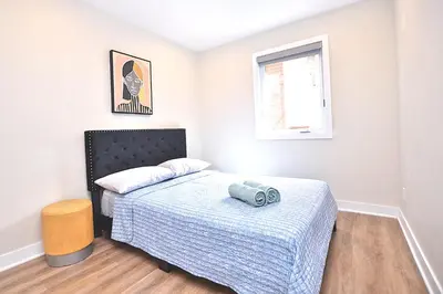 a small bedroom with a bed and a window at Beautiful 2BDR in Heart of Plateau Mont-Royal A in Montréal