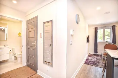 a white bathroom with a toilet and a door at Beautiful 2BDR in Heart of Plateau Mont-Royal A in Montréal