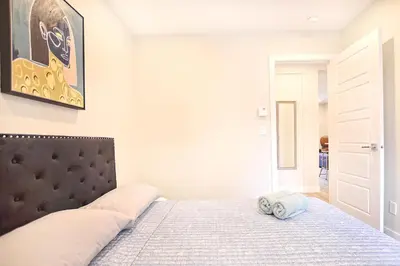 a bedroom with a bed with a black headboard at Beautiful 2BDR in Heart of Plateau Mont-Royal A in Montréal