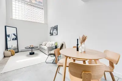 a living room with a table and chairs at Le Mile End by M11 - Luxurious Two-Floor 1BDR Loft in Montréal