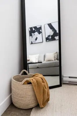 a wicker basket sitting on the floor in front of a mirror at Le Mile End by M11 - Luxurious Two-Floor 1BDR Loft in Montréal