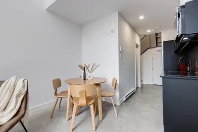 a kitchen and dining room with a table and chairs at Le Mile End by M11 - Luxury 1BDR Loft with Sofa Bed in Montréal