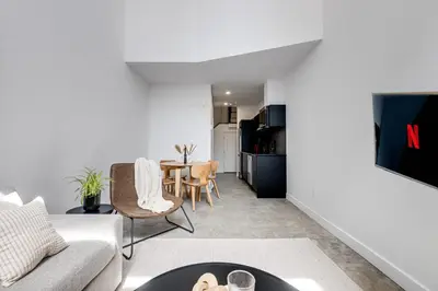 a living room with a couch and a table at Le Mile End by M11 - Luxury 1BDR Loft with Sofa Bed in Montréal