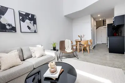 a living room with a couch and a table at Le Mile End by M11 - Modern & Stylish 1BDR with Sofa Bed in Montréal