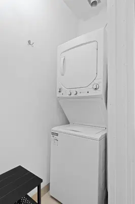 a white microwave sitting on top of a refrigerator at New Modern 2bdr Apartment in Little Italy in Montréal