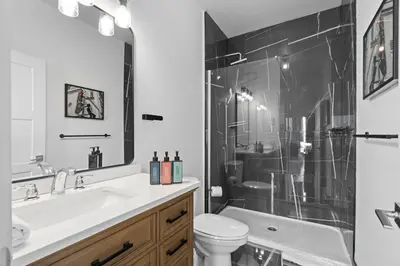 a bathroom with a sink and a toilet and a shower at New Modern 2bdr Apartment in Little Italy in Montréal