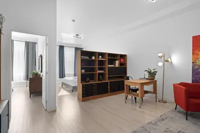 a living room with a desk and a table in a room at New Modern 2bdr Apartment in Little Italy in Montréal