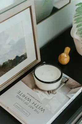 a bowl sitting on top of a magazine next to a picture at New Spacious and Cozy 2bdr Apartment in Montréal