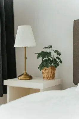 a table with a lamp and a potted plant on it at New Spacious and Cozy 2bdr Apartment in Montréal