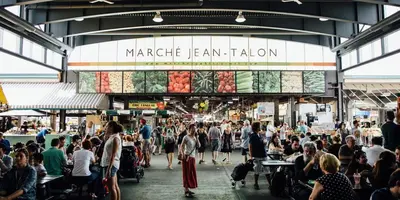 a crowd of people walking around a market hall at New Spacious and Cozy 2bdr Apartment in Montréal